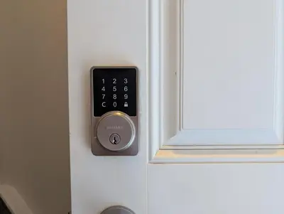 a remote control is attached to a door at Luxury Modern 2-Bedroom Suite in Airdrie