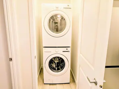 a washer and dryer in a small room at Luxury Modern 2-Bedroom Suite in Airdrie