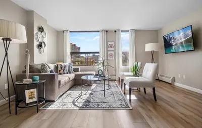 a living room with a couch and a table at Winter Prices Reduced for Stylish Condo & Easy to Mountains ! in Calgary
