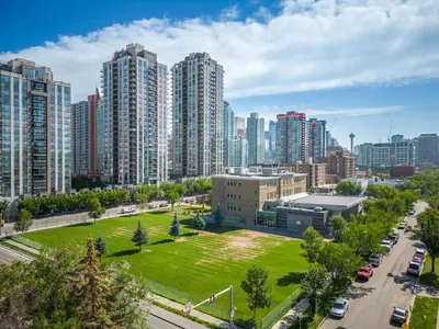 an aerial view of a city with tall buildings at Winter Prices Reduced for Stylish Condo & Easy to Mountains ! in Calgary