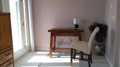 a wooden desk with a chair next to a window at Eagle Close Executive B&B in Prince Rupert