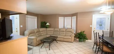 a living room with a couch and a table at Eagle Close Executive B&B in Prince Rupert