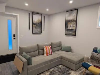 a living room with a couch and a chair at MIAT Apartment in Calgary