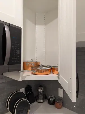 a kitchen cabinet with a sink and a microwave at MIAT Apartment in Calgary