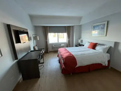 a hotel room with a bed and a desk at The Lodge Inn in Edmonton