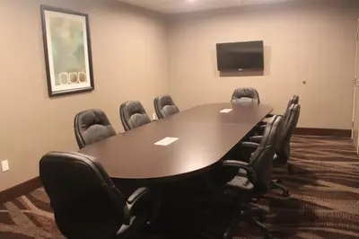 a conference room with a large table and chairs at Meridian Inn & Suites Lloydminster in Lloydminster
