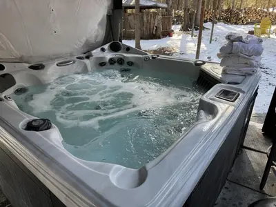 a jacuzzi tub filled with water in a tent at Rustic Cozy Cabin with hot tub in Bragg Creek