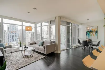 a living room with a couch and a table at Modern Downtown Apartment with Water Views in Vancouver