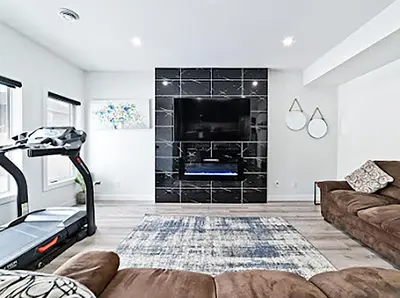 a living room with a couch and a fireplace at Cozy two bed apartment in Calgary