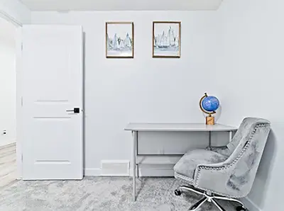 a office with a desk and a chair next to a door at Cozy two bed apartment in Calgary