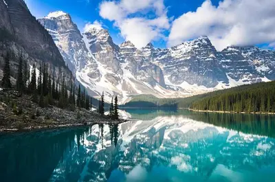 a mountain reflection in a lake with snow capped mountains at Cozy 2BR Private Basement Suite, Free Parking, WiFi, 1 Hr to Banff, 20 Min to City in Calgary