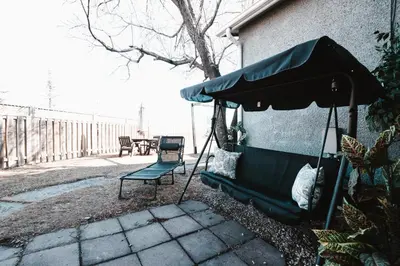 a patio with a bench and an umbrella at The Cloud off 16th - 2bd 1 ba in Calgary