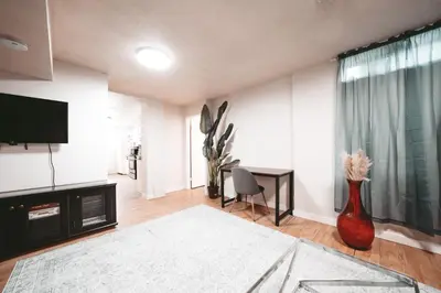 a living room with a television and a vase at The Cloud off 16th - 2bd 1 ba in Calgary