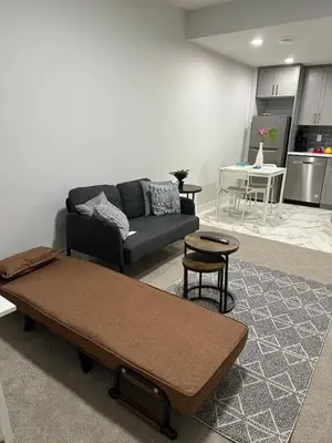 a living room with a couch and a table at The Modern Nest-one bedroom basement suite in Calgary