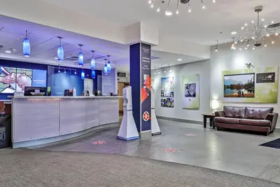 a lobby with a bar and a couch in a room at Solara Getaway 2BR Condo with Pool - Hot Tub - Gym - Spa in Canmore