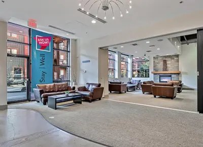 a lobby with couches and chairs in a building at Solara Getaway 2BR Condo with Pool - Hot Tub - Gym - Spa in Canmore