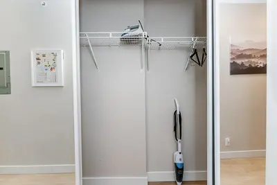 a room with a glass door with a vacuum at Gorgeous Unit in the Heart of Downtown in Vancouver