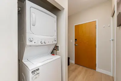 a kitchen with a washer and dryer in a room at Gorgeous Unit in the Heart of Downtown in Vancouver