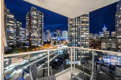 a view of a city at night from a balcony at Gorgeous Downtown Unit with City Views in Vancouver
