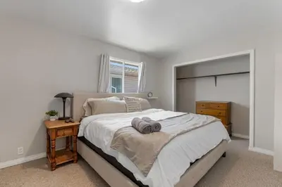 a bedroom with a large bed and a night stand at Hoodoo Hideout - 2BR House - Family Retreat - King Suite in Drumheller