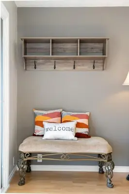 a bench with pillows on it in a room at Hoodoo Hideout - 2BR House - Family Retreat - King Suite in Drumheller