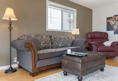 a living room with a couch and a chair at Hoodoo Hideout - 2BR House - Family Retreat - King Suite in Drumheller