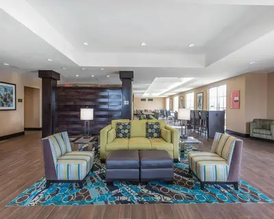 a lobby with couches and chairs in a hotel at Comfort Inn & Suites Airport North in Calgary