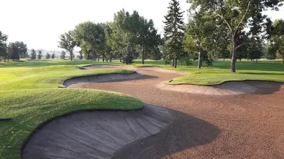 an aerial view of a golf course with twoavy depressionsacers at Group Stay, Sleeps 16! Near Downtown - 6BR Full Duplex, 2 Kitchens! FREE Banff Pass in Calgary