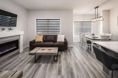 a living room with a couch and a dining room at Group Stay, Sleeps 16! Near Downtown - 6BR Full Duplex, 2 Kitchens! FREE Banff Pass in Calgary