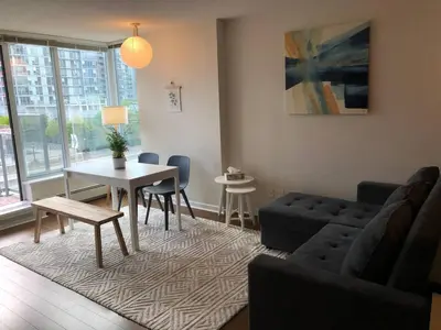 a living room with a couch and a table at Downtown Apartment in Vancouver