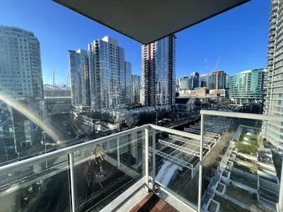 a view of a city from the balcony of a building at Downtown Apartment in Vancouver