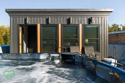 a indoor swimming pool with a water slide at Downtown Loft with Rooftop Hot Tub by StayIn in Fernie