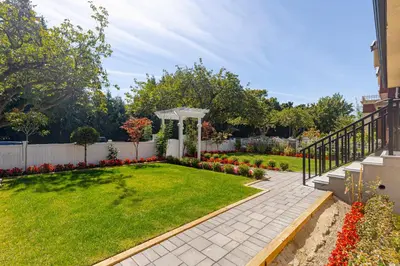 a garden with a gazebo and a lawn with flowers at Vancouver Cozy Cove in Vancouver
