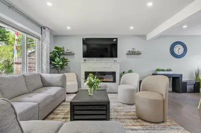 a living room with a couch and a fireplace at The Experience - Pool Hot Tub Theater Games Rm Pub in Calgary