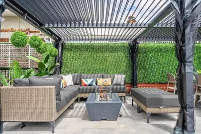 a pergola with a couch and a table at The Experience - Pool Hot Tub Theater Games Rm Pub in Calgary