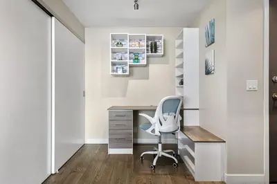 a home office with a desk and a chair at Executive Sky LUX - 2 BD 2BA Views Pool Patio & Gym in Calgary