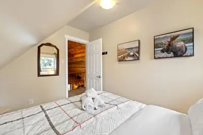 a bedroom with a bed with a stuffed animal on it at Lake Vibes 3 BD 1 BA Cottage steps from the Lake in Lacombe