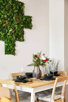a dining room table with black dishes and a plant at Eminence Sleek Studio City View in Edmonton