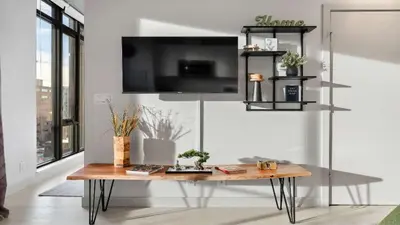 a living room with a table and a tv at Miso 2 BD - Skyline View Patio Gym Pool & AC in Calgary
