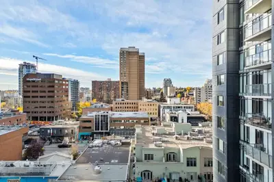 a city view of a city with tall buildings at Miso 2 BD - Skyline View Patio Gym Pool & AC in Calgary