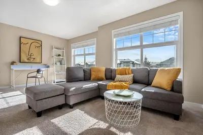 a living room with a couch and a table at The Trenta - 4BD 3BA 2 Kitchen Stunner in Calgary