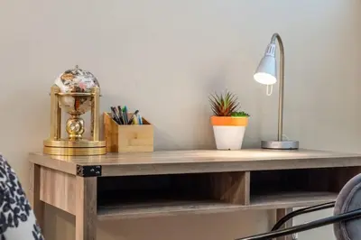 a wooden desk with a lamp and plants on it at The Trenta - 4BD 3BA 2 Kitchen Stunner in Calgary