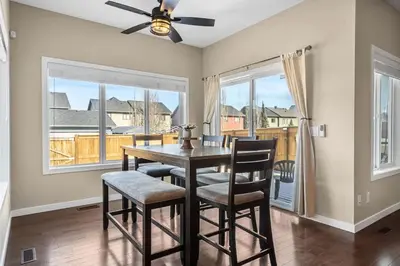 a dining room with a table and chairs and a window at The Venti - 3BD 2BA Yard Garage & Upper Suite in Calgary