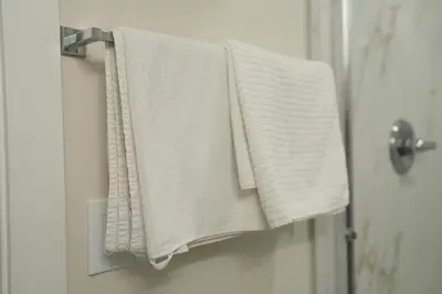 a towel hanging on a towel rack in a bathroom at Cozzy Cityscape & Airport Retreat in Calgary