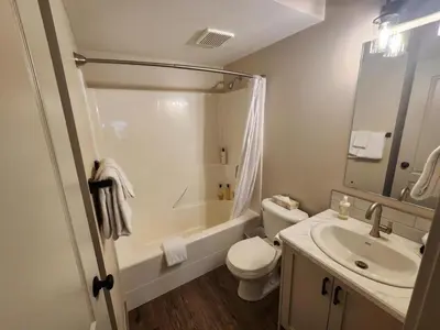 a bathroom with a toilet and a sink and a tub at Riverside Way by Fernie Lodging Company in Fernie