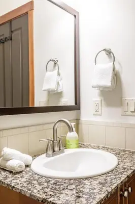 a bathroom counter with a sink and a mirror at Mountain Luxe - 50 Percent Off April & May in Canmore