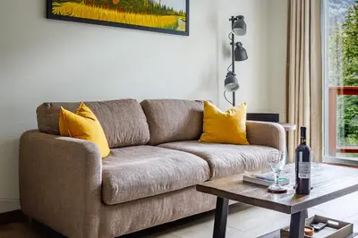 a living room with a couch and a table at Mountain Luxe - 50 Percent Off April & May in Canmore
