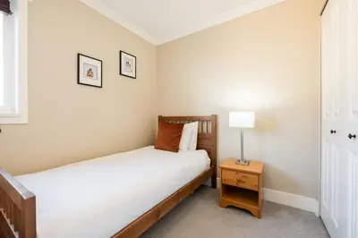 a bedroom with a bed and a table with a lamp at Gondola Heights by Outpost Whistler in Whistler