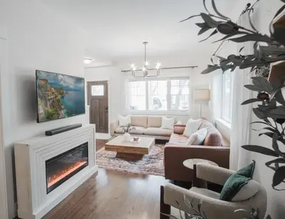 a living room with a couch and a fireplace at DOWNTOWN KINGBED 4Br FIREPLACE BIKELANE in Edmonton