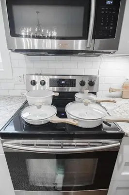 a stove top with two bowls on top of it at DOWNTOWN KINGBED 4Br FIREPLACE BIKELANE in Edmonton